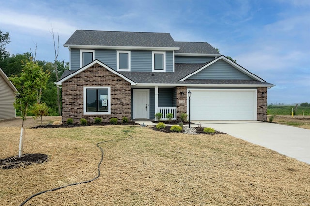 traditional-style house with brick siding, a shingled roof, a front lawn, concrete driveway, and an attached garage