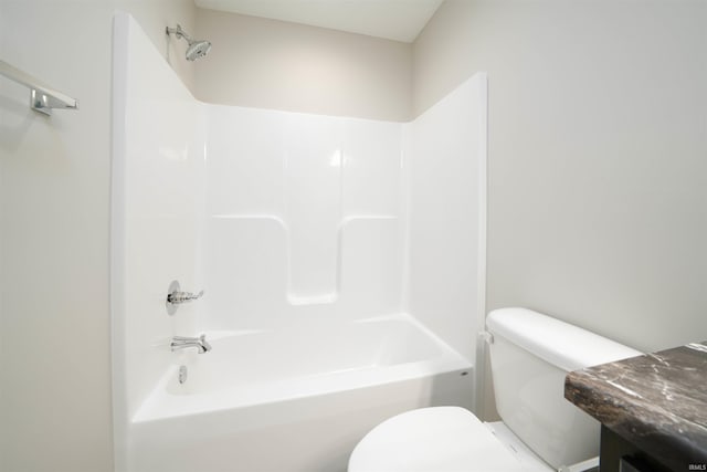 full bath featuring toilet, vanity, and shower / tub combination