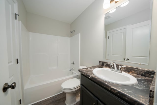 full bathroom with visible vents, toilet, wood finished floors, shower / bathing tub combination, and vanity