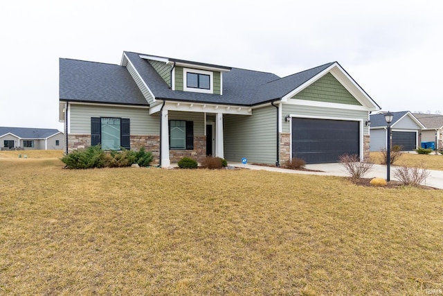 craftsman-style home featuring driveway, stone siding, an attached garage, and a front lawn