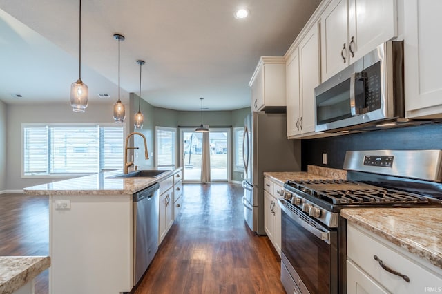 kitchen with a sink, appliances with stainless steel finishes, dark wood finished floors, and white cabinetry