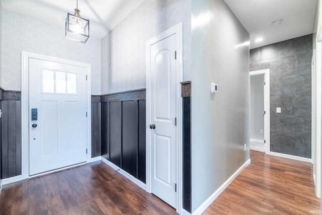 entryway with baseboards and dark wood-type flooring