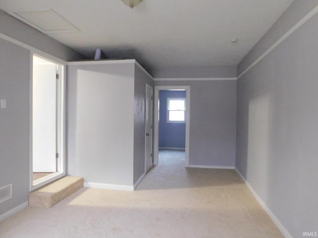 carpeted spare room featuring baseboards