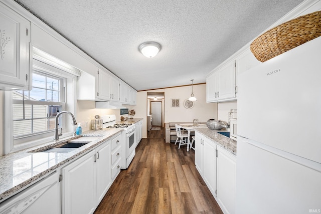 kitchen with a sink, white appliances, dark wood finished floors, and white cabinetry