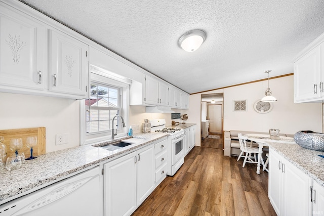 kitchen with white appliances, white cabinetry, lofted ceiling, and a sink