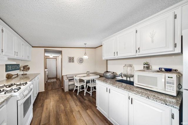 kitchen featuring decorative light fixtures, a textured ceiling, white appliances, white cabinetry, and dark wood-style flooring