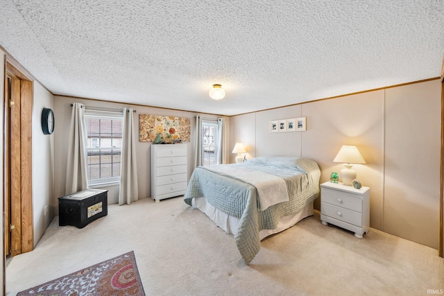 bedroom with ornamental molding, carpet flooring, and a textured ceiling