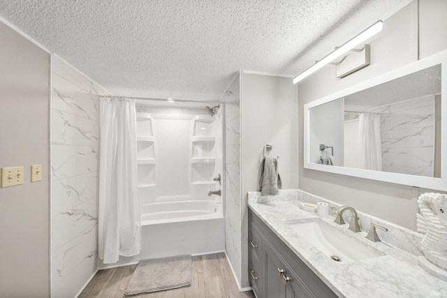 bathroom with shower / tub combo with curtain, a textured ceiling, vanity, and wood finished floors