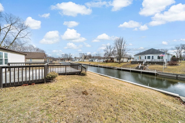 view of yard featuring a deck with water view and a residential view