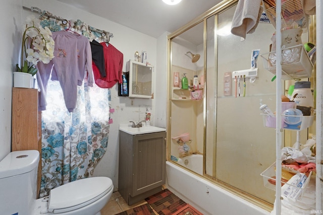 bathroom with vanity, toilet, and bath / shower combo with glass door