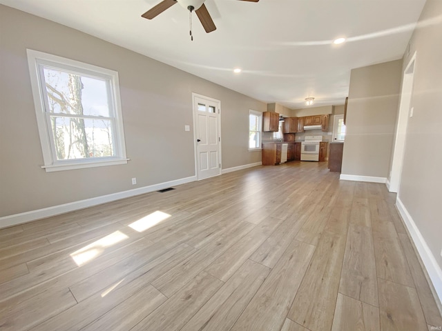 unfurnished living room with light wood-type flooring, visible vents, a ceiling fan, recessed lighting, and baseboards