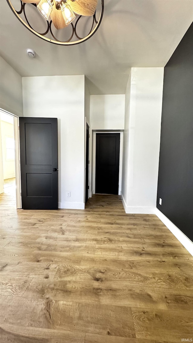 foyer entrance featuring a ceiling fan, baseboards, and wood finished floors