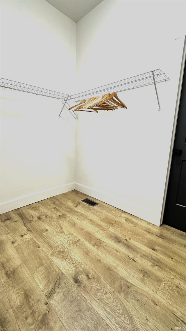 spacious closet with visible vents and light wood-style floors