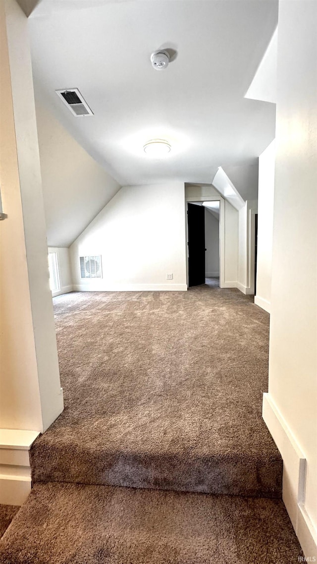 bonus room with visible vents, carpet flooring, baseboards, and lofted ceiling