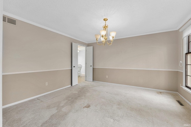 empty room featuring carpet, visible vents, baseboards, an inviting chandelier, and crown molding