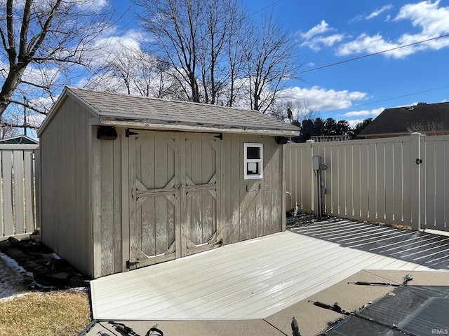 view of shed featuring fence