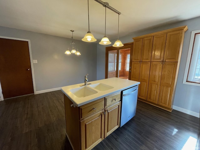 kitchen featuring brown cabinets, a center island with sink, a sink, dark wood finished floors, and dishwasher