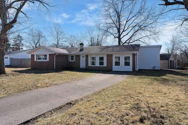 ranch-style house featuring a front lawn, brick siding, and a chimney