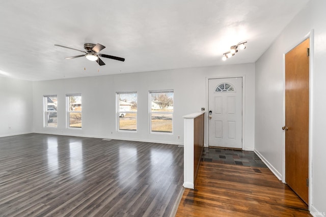 entryway with baseboards, ceiling fan, and dark wood-style flooring