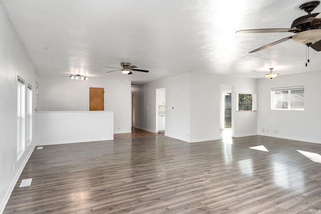 unfurnished living room with a healthy amount of sunlight, wood finished floors, and ceiling fan