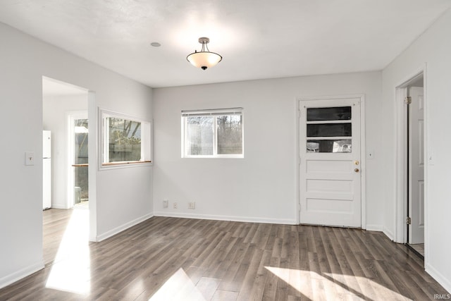 empty room with wood finished floors and baseboards