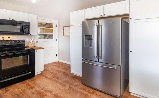 kitchen with baseboards, white cabinets, black appliances, and light wood-style floors