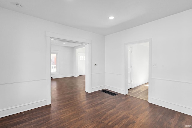 empty room featuring recessed lighting, visible vents, baseboards, and wood finished floors