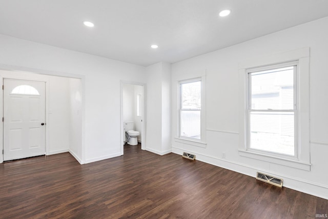 foyer with dark wood finished floors, recessed lighting, visible vents, and baseboards