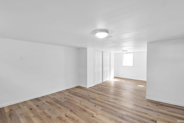 below grade area featuring baseboards and wood finished floors