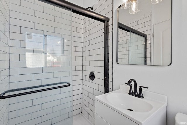 full bath featuring a sink, toilet, and a stall shower