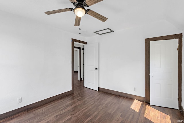 spare room with a ceiling fan, dark wood-style floors, and baseboards