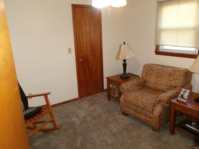 sitting room featuring baseboards and carpet