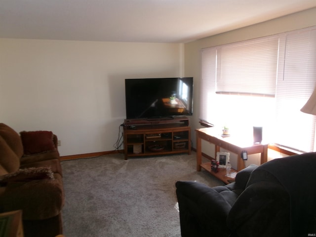 carpeted living room featuring baseboards