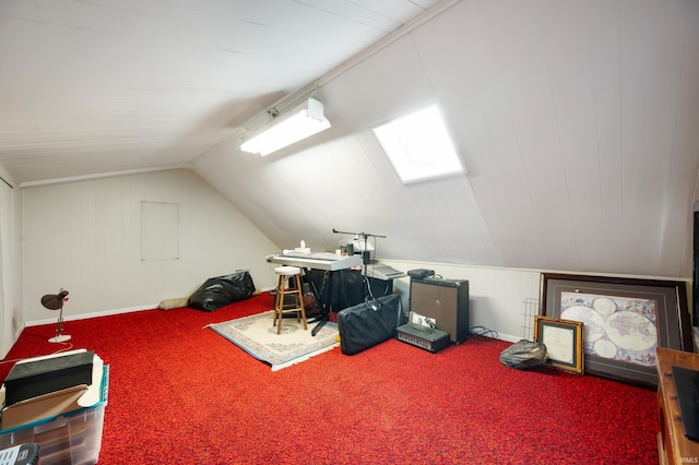 interior space with vaulted ceiling with skylight and carpet floors