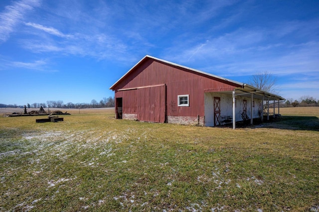 view of pole building featuring a rural view and a yard