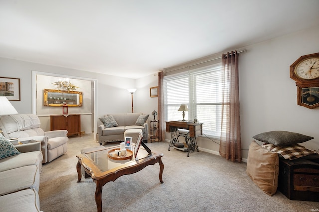 living area with light colored carpet and baseboards