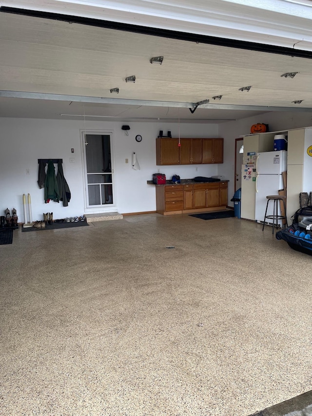 garage with freestanding refrigerator