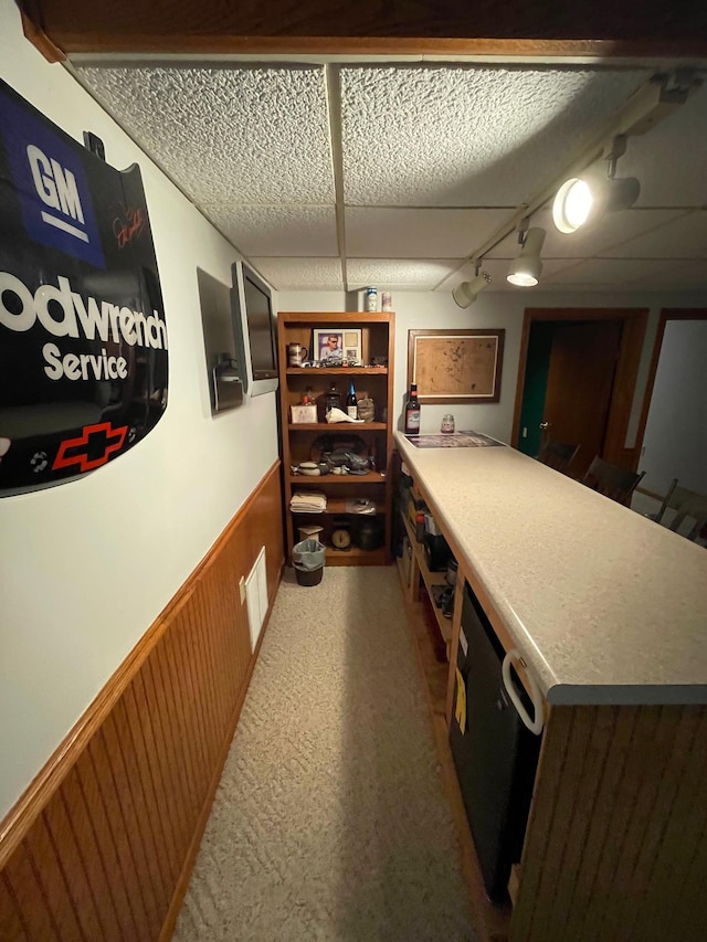 interior space featuring a wainscoted wall, a textured ceiling, visible vents, and track lighting