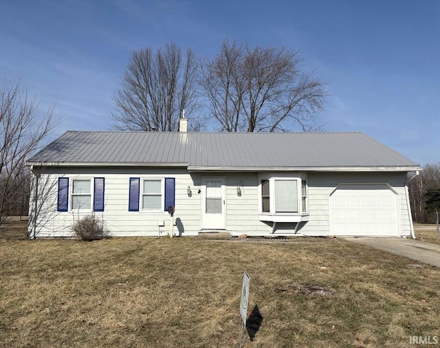 ranch-style house with driveway, a front yard, an attached garage, metal roof, and a chimney