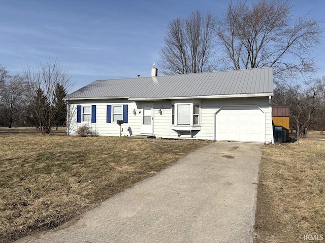 ranch-style house featuring a garage, driveway, a front yard, metal roof, and a chimney