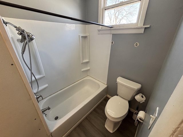 full bathroom featuring baseboards, toilet,  shower combination, and wood finished floors