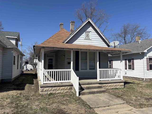 view of front of house with a porch and a chimney