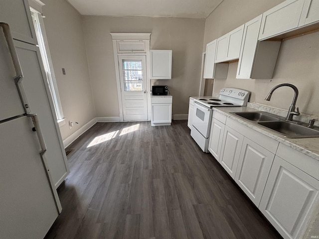 kitchen with white appliances, baseboards, dark wood-type flooring, and a sink