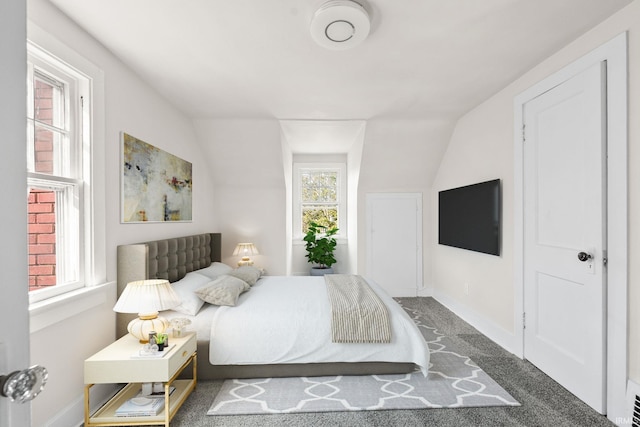 bedroom featuring vaulted ceiling and baseboards