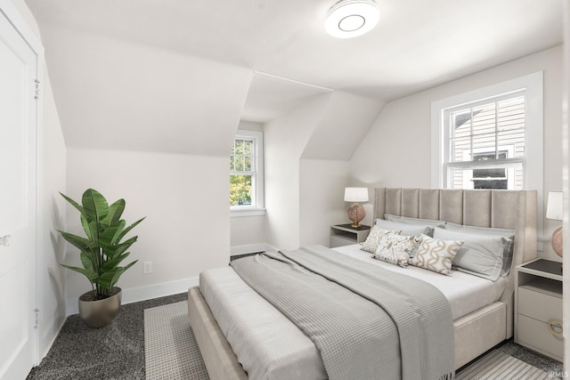 bedroom with baseboards and vaulted ceiling