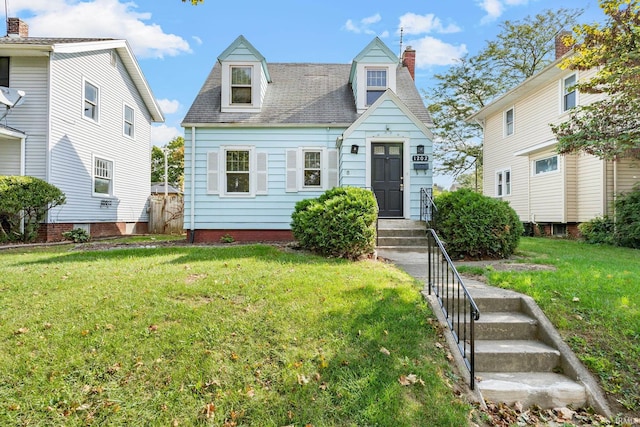 new england style home with a chimney and a front yard