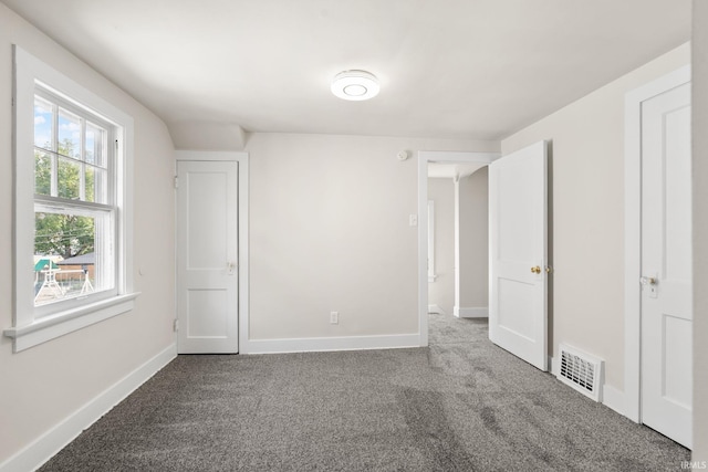 unfurnished bedroom featuring visible vents, baseboards, and carpet floors