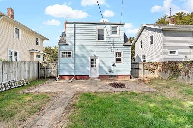 back of property featuring a fenced backyard, a patio, and a yard