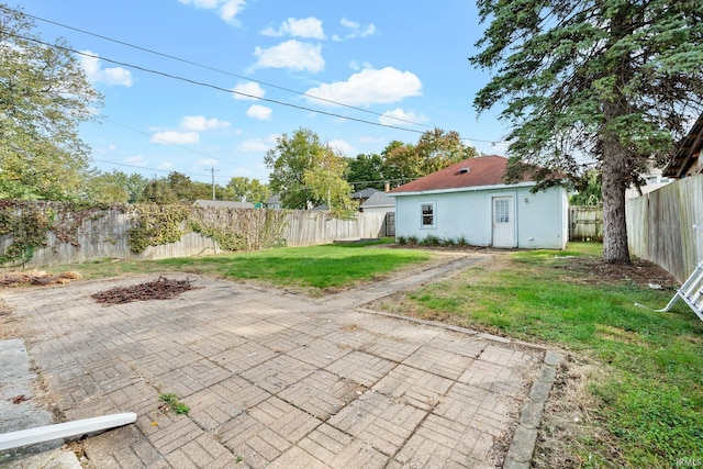 view of patio / terrace with an outdoor structure and a fenced backyard