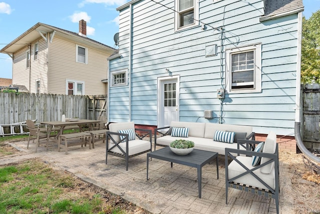 view of patio / terrace featuring an outdoor living space and fence